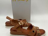 a pair of brown sandals with gold buckles on them