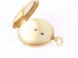an image of a gold pocket watch with a white background