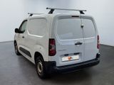 a white van parked in a room with a black floor