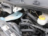 a close up of a car ' s engine with its hood open