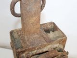 a rusted metal object with a handle on top of it