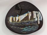 a black plate with a picture of a castle on it