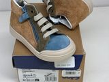 pair of children ' s shoes in a box on a white surface