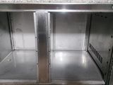 a metal cabinet with two open doors in a kitchen