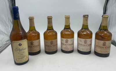 six bottles of wine are lined up in a row on a table