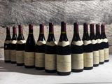 many bottles of wine lined up on a table