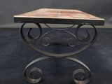 a small table with a marble top and metal legs