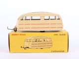 toy bus sitting on top of a cardboard box on a white surface