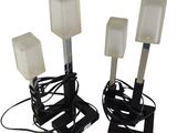 two black and white lamps on a metal stand with wires