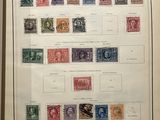 an old framed picture of a collection of stamps on a wall