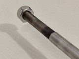 a close up of a screw on a piece of metal