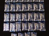 a lot of packets of toothpaste sitting on a table