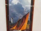 a picture of a sailboat in a picture frame on the wall