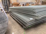 un gros tas de treillis métallique dans un entrepôt, posé sur des palettes
