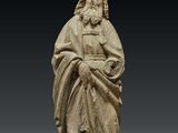 a statue of a man in a robe holding a book