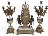 four different types of clocks on display on a white surface