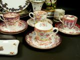 many different types of tea cups and saucers on the table