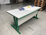 a white table with green legs and a box of cereal on the table