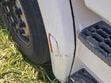 a close up view of a truck ' s front tire