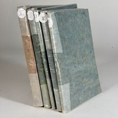 three books are stacked on top of each other on a white surface