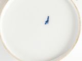 a white plate with a blue bird on it