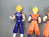 three figurines of goku and vegeta from dragon ball z