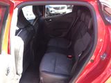 the back seat of a red car with the door open