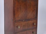 an image of a small wooden chest of drawers