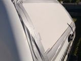 a white van that is parked on the side of the road