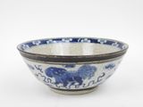a blue and white bowl with an elephant design on it