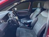 the interior of a red car with black leather seats and a steering wheel
