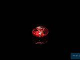 a red candle that is lit up in the dark