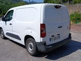 a white van that is parked on the side of the road