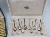six spoons in a box on a table