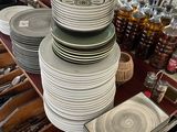 many plates and bowls on a table in a store