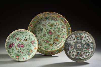 three chinese famille plates with floral designs on them