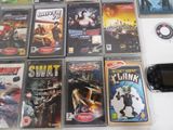 a lot of video games on a table with a cell phone