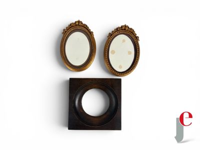 two oval mirrors and a wooden frame on a white surface