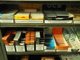 a shelf of cigarettes and cigarettes in a store