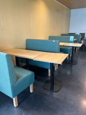 tables and chairs are lined up in a row in a restaurant