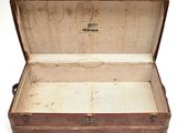 an old suitcase that is open on a white surface