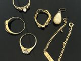 une table noire sur laquelle sont posés un tas de bagues et un collier