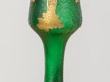 un verre vert orné de motifs dorés