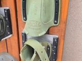 a pair of skis and a pair of knee pads hanging on a wall