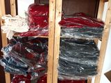 a shelf with many different colored shirts on it