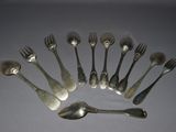a lot of silver spoons and forks arranged in a circle
