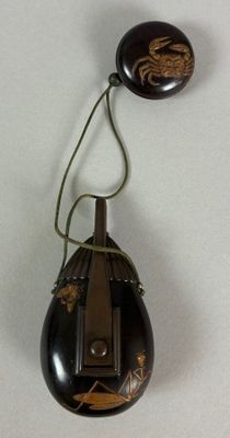 a picture of a black and gold object with a spider on it