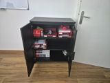 a black cabinet with a bunch of boxes on it