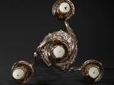 two silver candles are sitting on top of each other