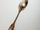 a spoon that is sitting on a white surface
